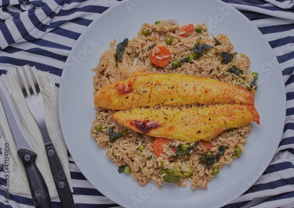 Fototapeta Smoked basa fillet with curried rice and vegetables.