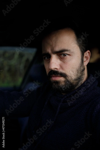 Fototapeta A man in a car