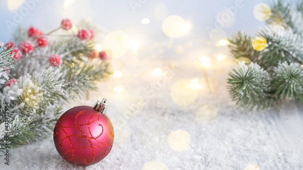Fototapeta Red Christmas ball on the background of fir branches. Image with selective focus