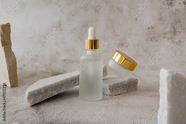 Fototapeta Non-binary unisex cosmetic set mockup. Matte Glass dropper bottles jar with a pipette for imprint branding copy space with marble background. Organic Spa Cosmetics