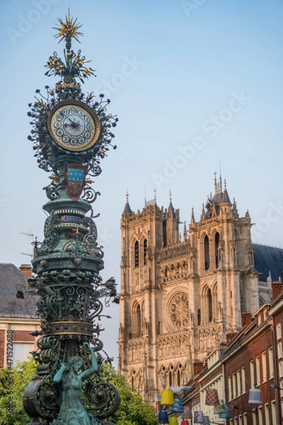 Fototapeta Amiens, France/07,26,2018: 
View of the Dewailly clock in Amiens with the Cathedral in the background