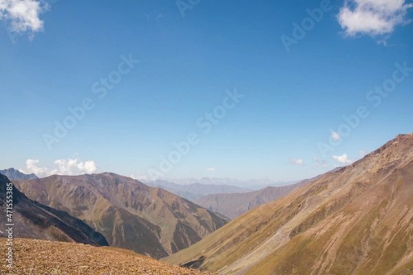 Fototapeta Panoramic view on a mountain chain seen from the Chaukhi Pass in the Greater Caucasus Mountain Range in Georgia, Kazbegi Region. The trail connects the villages of Juta and Roshka. Peak Sosuptano