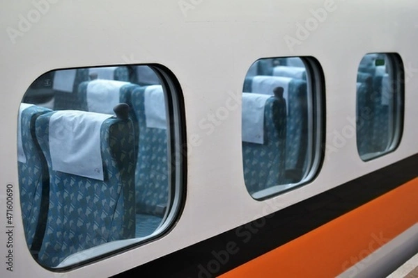 Fototapeta Empty blue cushioned subway train seats as seen from the train platform outside the train window