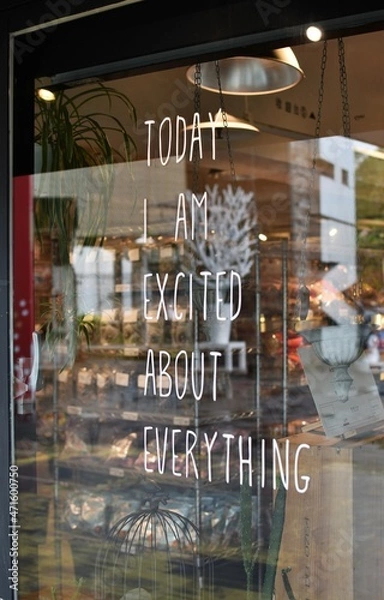 Fototapeta Positive inspiring message written on a glass wall of a retail storefront