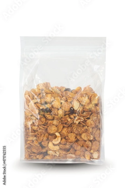 Fototapeta Caramel cornflakes in plastic bag package isolated on white.