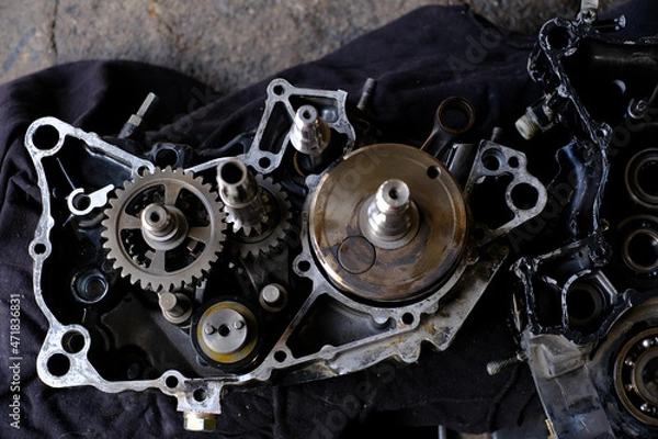 Fototapeta Assemble the motorcycle engine gear by a maintenance technician and check it.