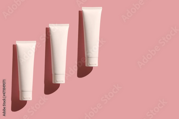 Obraz White container of cosmetic cream on a pink background.