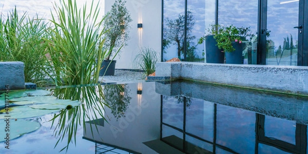 Obraz Modern house with a glass wall and its reflection on the surface of a decorative pond