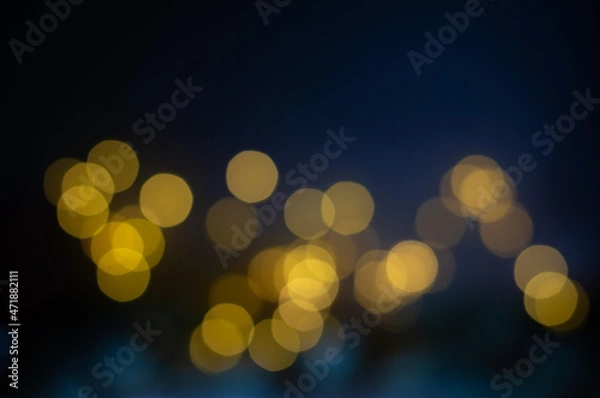 Obraz Blurred bokeh lights background on dark background.