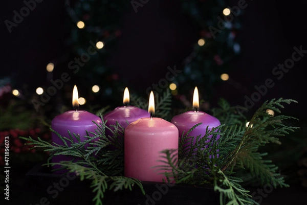 Obraz Three purple and one pink advent candles in Christmas eve.