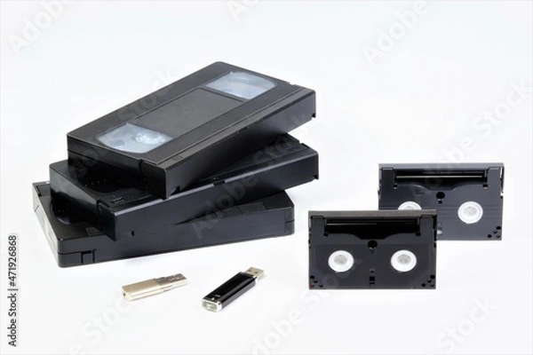 Fototapeta Videotapes and flash drives. The concept of digitizing data from technologically obsolete media to modern ones.