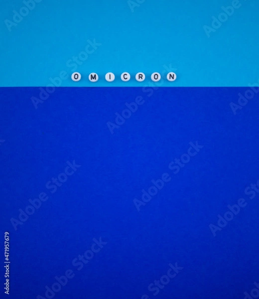 Fototapeta Covid-19 new variant - Omicron text on blue background