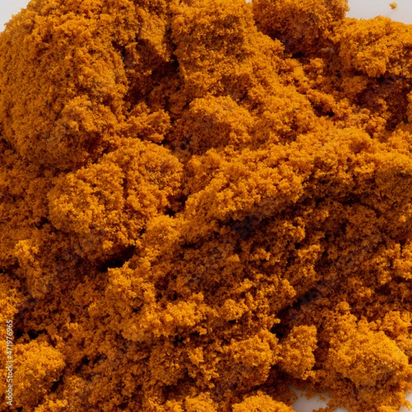 Fototapeta Detailed and large close up shot of powdered curcuma spice.