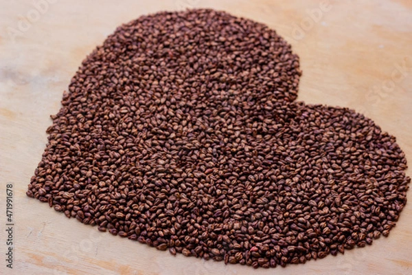 Fototapeta 
Grape seeds laid out in the shape of a heart. Cardiovascular care symbol
