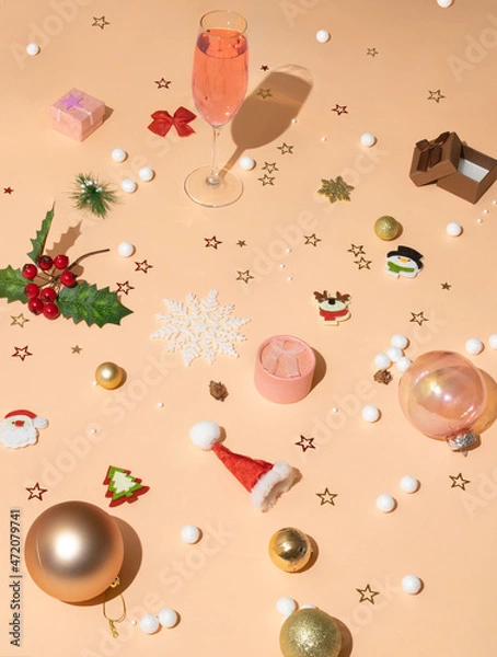 Obraz Creative festive pattern made with champagne glass and ornaments, gift boxes and baubles in rose pink, coral and pastel peach colors. New Year party, Christmas and winter holidays minimal concept.