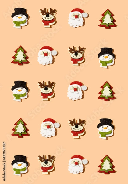 Fototapeta Creative Christmas pattern made with decorations: reindeer, snowman, santa claus and christmas tree on pastel peach, coral background. Minimal fun and happy winter holidays and New Year idea.