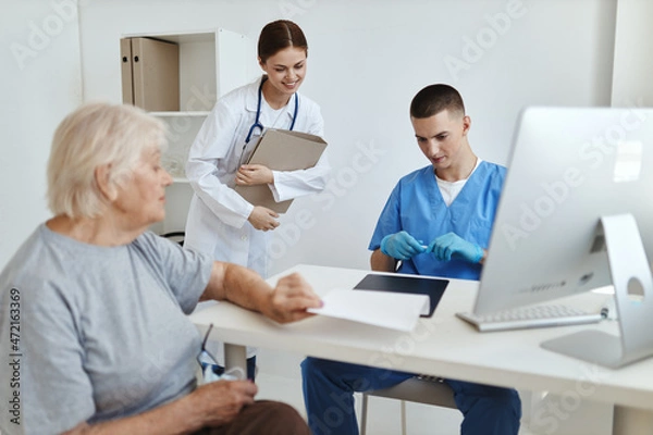 Fototapeta elderly woman at the hospital reception doctor and nurse treatment