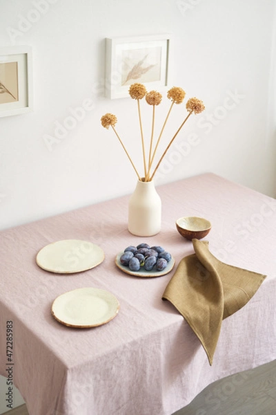 Fototapeta Modern dining table setting. Only natural materials - earthenware, linen textiles, dried flowers. Side view.