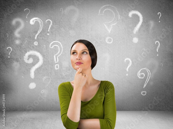 Obraz Beautiful woman with questioning expression and question marks a