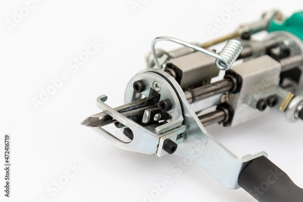 Fototapeta Tufting gun on white background. Cut and pile gun. Carpet hand tufting machine. Machine needle