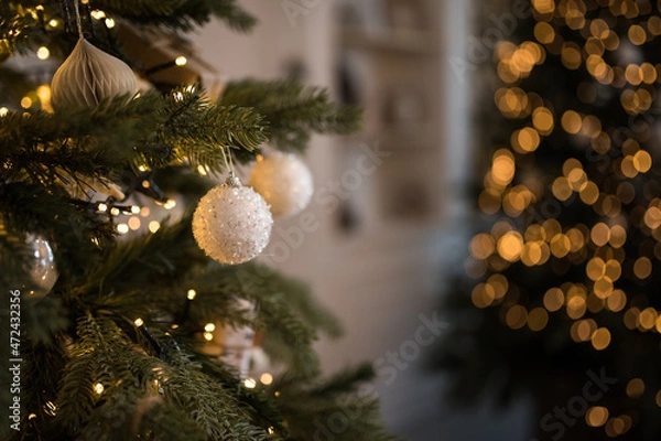 Fototapeta Decorative christmas white balls on a tree with bokeh in the background, shallow depth of field, new year decor, merry christmas