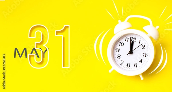 Fototapeta May 31st . Day 31 of month, Calendar date. White alarm clock with calendar day on yellow background. Minimalistic concept of time, deadline. Spring month, day of the year concept.