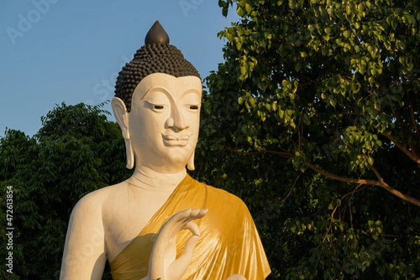 Fototapeta Buddha head statue, monument, meditation, The face of the Buddha has a smile. Being meditation, The picture shows the feeling of peace and peacefulness.