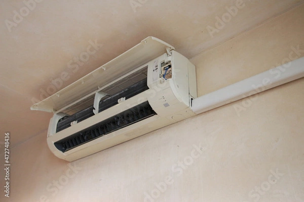 Obraz air conditioner mechanic working air cleaning service at home isolate