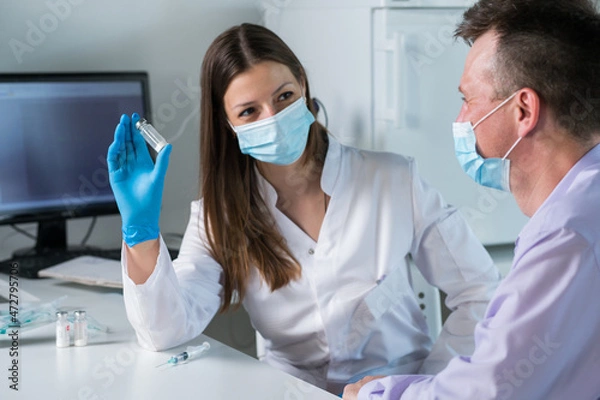 Fototapeta Man with face mask getting vaccinated, coronavirus, covid-19 and vaccination concept.