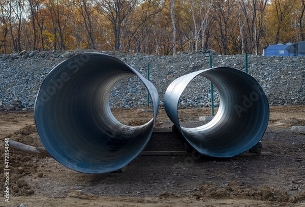 Obraz Large diameter metal pipes at a construction site.