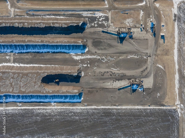 Fototapeta Aerial photo showing large rows of harvested sugar beets waiting to go to sugar beet factory. Drone straight above, wide view. Winter time, North Dakota.