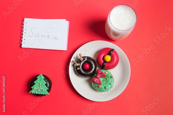 Fototapeta Letter, Donuts cookies and glass of milk for Santa on red background, concept Christmas and holiday. 