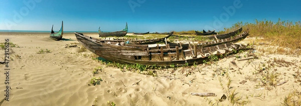 Fototapeta Abandoned boats on a beach in Myanmar.