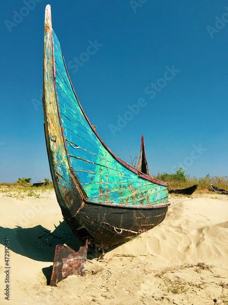Fototapeta Abandoned boats on a beach in Myanmar.