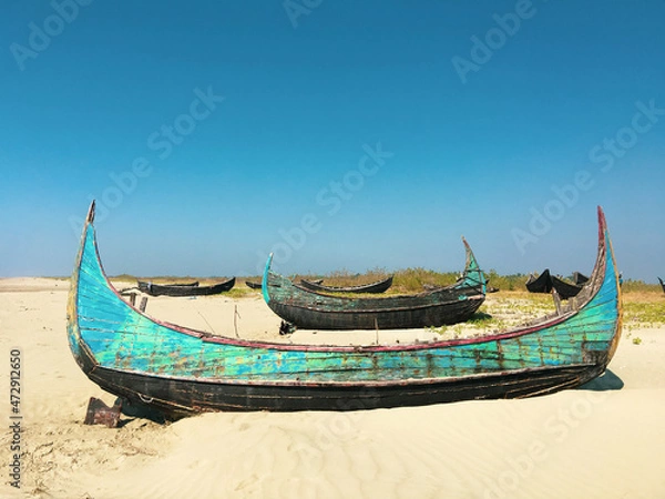Fototapeta Abandoned boats on a beach in Myanmar.
