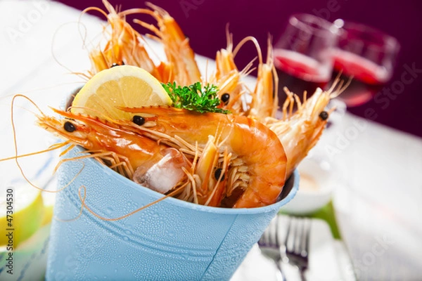 Obraz Bucket of king prawns on ice