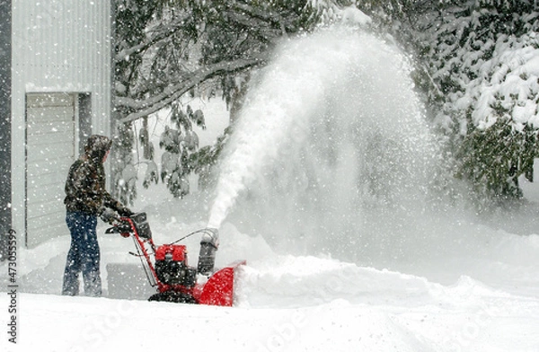 Obraz Blowing snow and clearing a path during winter