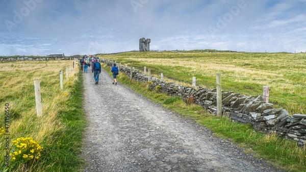 Fototapeta Group of people on road leading to Moher Tower at Hags Head in Cliffs of Moher, popular tourist attraction, Wild Atlantic Way, County Clare, Ireland