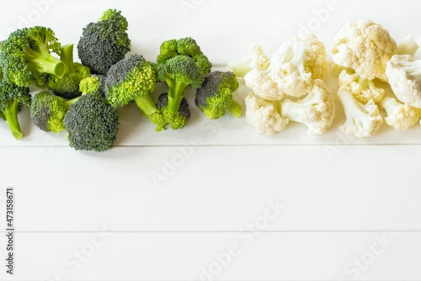 Fototapeta fresh broccoli and cauliflower on the table. white background with fresh broccoli and cauliflower. copy space and vegetables.