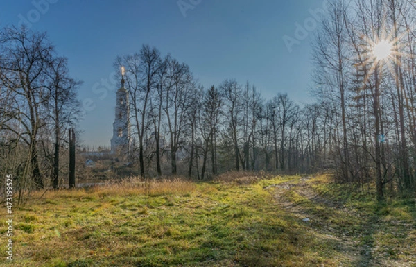 Fototapeta The restored Nikolo-Berlyukovsky Monastery on a sunny autumn day against the background of trees near the Vorya River. Avdotino. Moscow oblast.