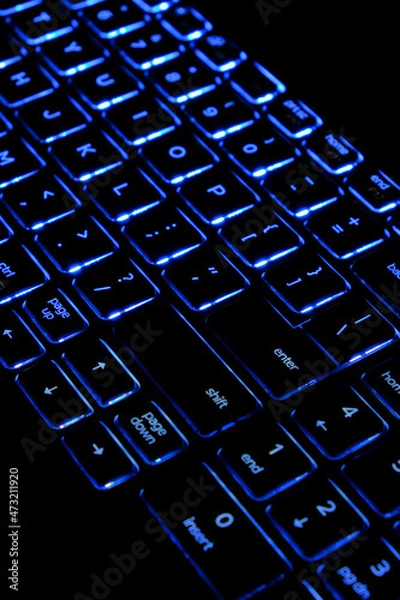 Fototapeta Computer keyboard highlighted in blue