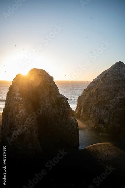 Fototapeta Two big rocks separated by the beach, on a beautiful landscape in Chile, at sunset