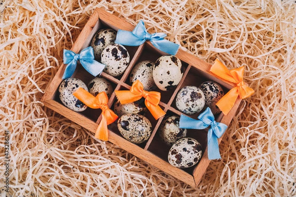 Obraz Little raw quail eggs in the wooden box 