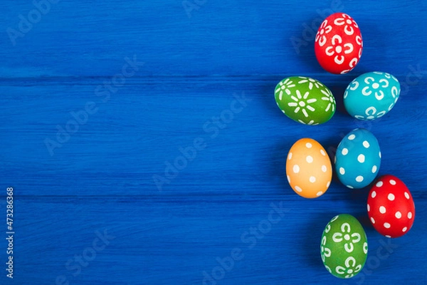 Obraz Colorful easter eggs on blue color wood background with space.