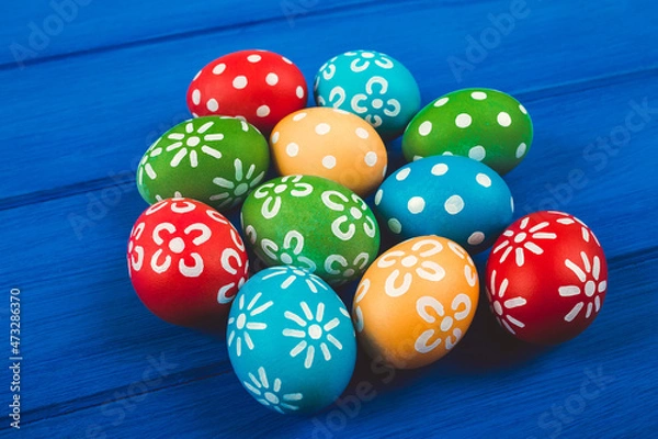 Obraz Colorful easter eggs on blue color wood background with space.