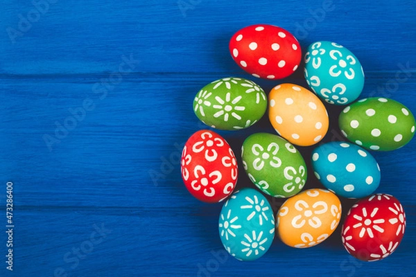 Obraz Colorful easter eggs on blue color wood background with space.