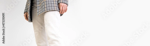 Obraz Female in white pants and casual jacket on a white background, studio fashion banner with copy space