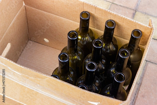 Fototapeta 
Empty olive-colored wine bottles packed in a box and prepared for bottling