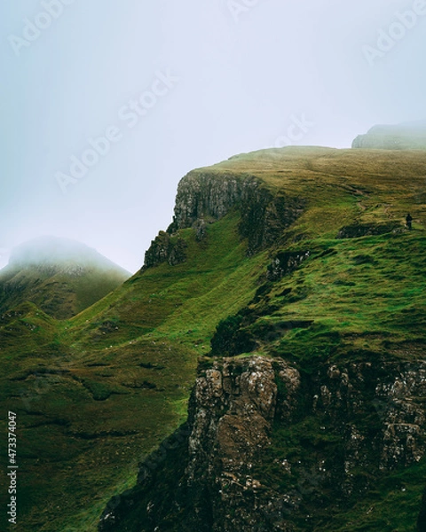 Obraz man hiking in distance with clouds