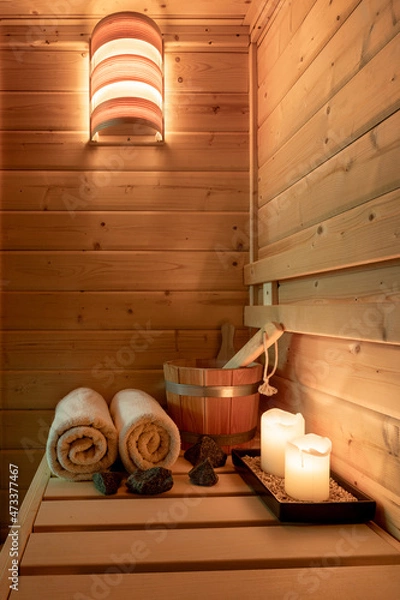 Obraz Interior of a small Finnish wooden sauna with sauna accessories.